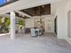 Modern outdoor kitchen and dining area with pool views at 1827 Morris St, Sarasota, FL 34239