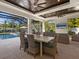 Relaxing outdoor kitchen and dining area with a view of the pool at 1827 Morris St, Sarasota, FL 34239