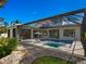 Tranquil pool and spa with a covered patio and rock landscaping at 1827 Morris St, Sarasota, FL 34239