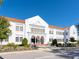 White school building with red tile roof, and landscaping at 1827 Morris St, Sarasota, FL 34239