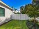 Landscaped side yard with white fence and grassy area at 1827 Morris St, Sarasota, FL 34239