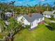 House with grey roof, green lawn, and swimming pool at 202 23Rd W St, Bradenton, FL 34205