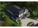 Aerial view of a two-story home with a three-car garage surrounded by mature trees and landscaping at 217 S Shade Ave, Sarasota, FL 34237