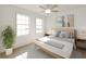 Bright bedroom featuring light wood flooring, neutral decor, ceiling fan, and natural light from the windows at 217 S Shade Ave, Sarasota, FL 34237