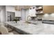 Modern kitchen featuring island with marble countertop, gold fixtures, and stainless steel appliances at 217 S Shade Ave, Sarasota, FL 34237