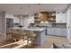 Modern kitchen with a large island, stainless steel appliances, and stylish pendant lighting at 217 S Shade Ave, Sarasota, FL 34237