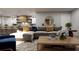 Living room featuring a grey sectional couch, a wooden coffee table, and an adjacent kitchen at 217 S Shade Ave, Sarasota, FL 34237