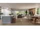 Spacious living room with open floor plan, dining area, kitchen island, and natural light at 217 S Shade Ave, Sarasota, FL 34237