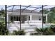 Beautiful screened-in pool and patio with spa, lounge chairs, and outdoor dining area at 217 S Shade Ave, Sarasota, FL 34237