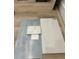 Sample of home tile including grey and light tiles, marble square, and white trim on wood floor at 217 S Shade Ave, Sarasota, FL 34237