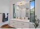 Modern bathroom with double vanity and a large mirror at 2248 Novus St, Sarasota, FL 34237