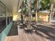 Large wooden deck surrounded by palm trees in the backyard at 2427 Walker Cir, Sarasota, FL 34234