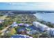 Wide aerial view of waterfront community with tennis courts and pool at 294 Hidden Bay Dr # 203, Osprey, FL 34229