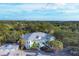 An aerial view showcasing a light green building with a metal roof and its surroundings at 294 Hidden Bay Dr # 203, Osprey, FL 34229