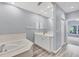 Bathroom with vanity, tub and access to bedroom at 294 Hidden Bay Dr # 203, Osprey, FL 34229
