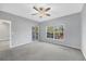 Spacious bedroom with balcony access and ceiling fan at 294 Hidden Bay Dr # 203, Osprey, FL 34229