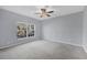 Bright bedroom with ceiling fan and large window at 294 Hidden Bay Dr # 203, Osprey, FL 34229