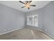 Spacious bedroom with ceiling fan and large window with shutters at 294 Hidden Bay Dr # 203, Osprey, FL 34229