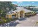 Exterior of community clubhouse with metal roof and landscaping at 294 Hidden Bay Dr # 203, Osprey, FL 34229