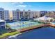 Aerial view of community with pool, tennis courts, and clubhouse at 294 Hidden Bay Dr # 203, Osprey, FL 34229