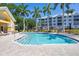Refreshing community pool surrounded by palm trees at 294 Hidden Bay Dr # 203, Osprey, FL 34229