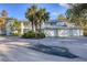 Front view of a light green two-story building with a metal roof and attached garages at 294 Hidden Bay Dr # 203, Osprey, FL 34229