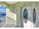 White front door with etched glass and light fixture on a balcony at 294 Hidden Bay Dr # 203, Osprey, FL 34229