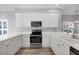 Spacious kitchen with white cabinets and stainless steel appliances at 294 Hidden Bay Dr # 203, Osprey, FL 34229