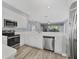 Modern kitchen with island, white cabinets, and stainless steel appliances at 294 Hidden Bay Dr # 203, Osprey, FL 34229