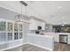 Eat-in kitchen with white cabinets and stainless steel appliances at 294 Hidden Bay Dr # 203, Osprey, FL 34229