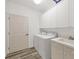 Laundry room with washer, dryer, cabinets, and sink at 294 Hidden Bay Dr # 203, Osprey, FL 34229