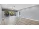Living room with light gray walls, wood-look floors, and sliding glass doors at 294 Hidden Bay Dr # 203, Osprey, FL 34229