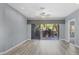 Living room with sliding glass doors opening to a balcony, ceiling fan, and gray walls at 294 Hidden Bay Dr # 203, Osprey, FL 34229