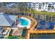 Community pool with a wooden boardwalk and a tiki hut at 294 Hidden Bay Dr # 203, Osprey, FL 34229