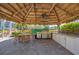 Covered outdoor kitchen and dining area near the pool at 294 Hidden Bay Dr # 203, Osprey, FL 34229