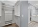 Large walk-in closet with shelving and drawers at 294 Hidden Bay Dr # 203, Osprey, FL 34229