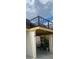Private balcony with metal railing overlooking landscaped grounds at 3218 Ramblewood N Dr # 19C2, Sarasota, FL 34237
