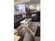 Spacious living room with a sectional sofa, coffee table, and view into the kitchen at 3218 Ramblewood N Dr # 19C2, Sarasota, FL 34237