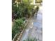 Landscaped front yard with lush tropical plants and stone border at 3218 Ramblewood N Dr # 19C2, Sarasota, FL 34237