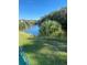 Peaceful pond view with lush landscaping at 3218 Ramblewood N Dr # 19C2, Sarasota, FL 34237