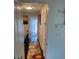 Upstairs hallway with wood floors and floral runner at 3218 Ramblewood N Dr # 19C2, Sarasota, FL 34237