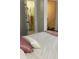 Bright bedroom with ensuite bathroom and a view of the hallway at 3218 Ramblewood N Dr # 19C2, Sarasota, FL 34237