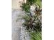 Landscaped walkway with tropical plants and stone at 3218 Ramblewood N Dr # 19C2, Sarasota, FL 34237