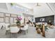 Modern dining area with a large wooden table and white chairs at 3631 San Remo Ter, Sarasota, FL 34239