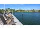 Relaxing waterfront dock with wooden chairs at 3631 San Remo Ter, Sarasota, FL 34239