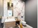 Modern powder room with marble walls and floating vanity at 3631 San Remo Ter, Sarasota, FL 34239