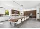 Modern kitchen with white cabinetry, large island, and wood accents at 3631 San Remo Ter, Sarasota, FL 34239