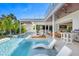 Inviting pool area with lounge chairs and outdoor kitchen at 3631 San Remo Ter, Sarasota, FL 34239