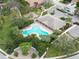 Aerial view of community pool with surrounding landscaping and a playground at 3636 Summerwind Cir, Bradenton, FL 34209