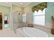 Spa-like bathroom with a soaking tub, walk-in shower, and dual sinks at 3636 Summerwind Cir, Bradenton, FL 34209